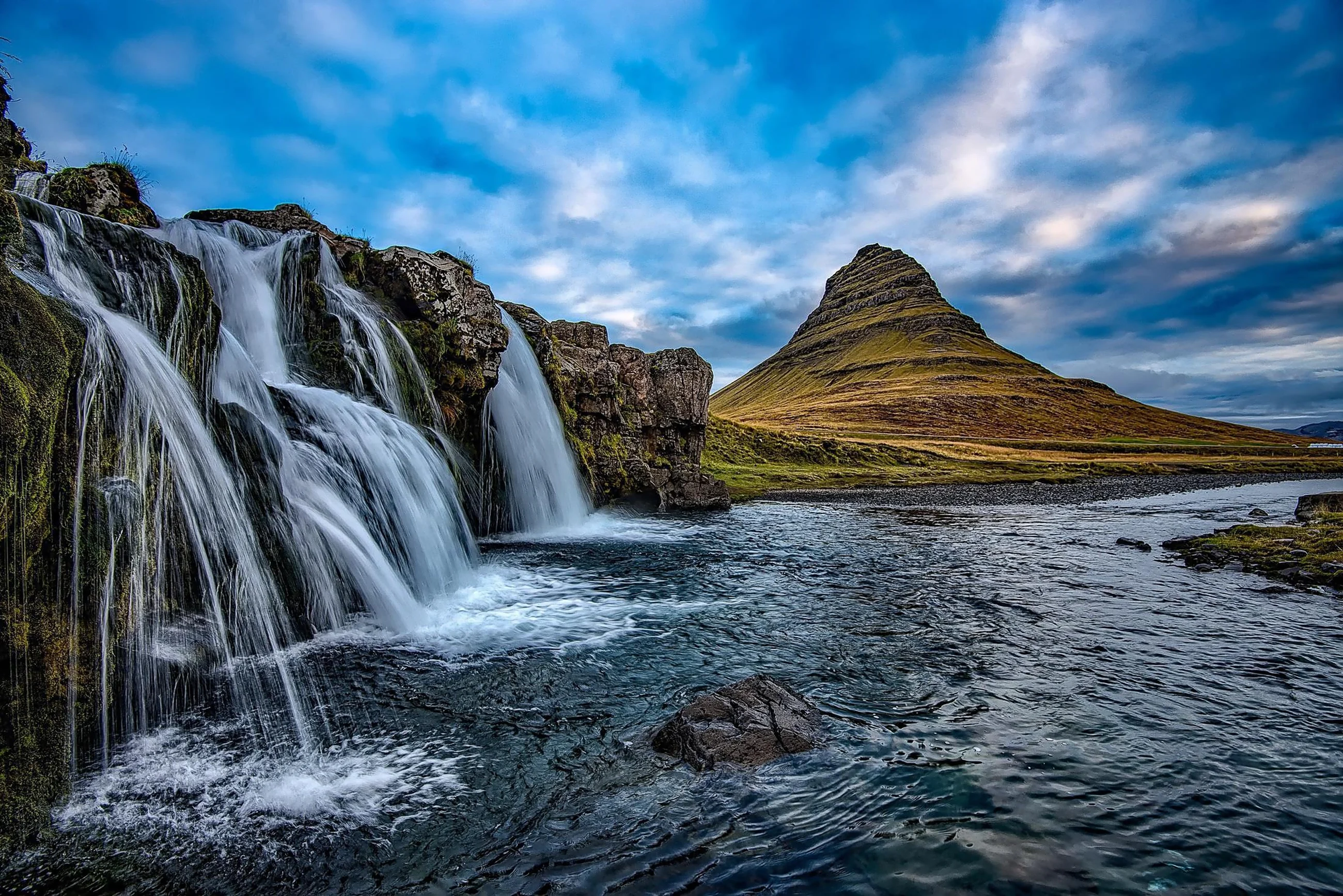 Waterfalls flowing beneath a mountain